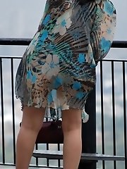 12 pictures - Wind upskirt - Wind lifts her dress's skirt up