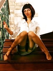 27 pictures - Upskirts amateur in beige stockings sits on the stairs